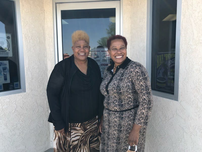 Karen Harper and sister Carrie Williams standing outside their beauty supply store