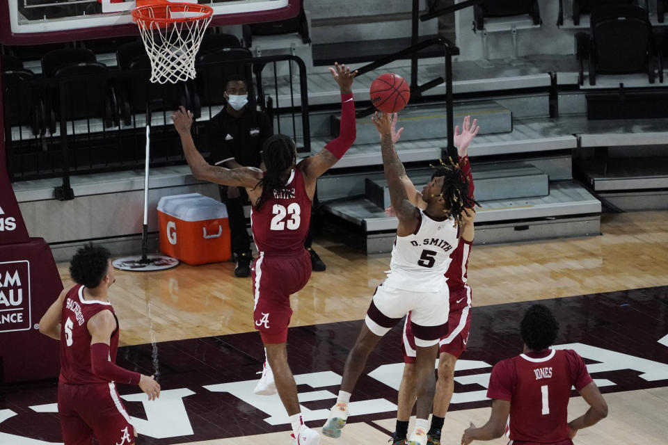 Mississippi State guard Deivon Smith (5) shoots past a block attempt by Alabama guard John Petty Jr. (23) during the second half of an NCAA college basketball game in Starkville, Miss., Saturday, Feb. 27, 2021. (AP Photo/Rogelio V. Solis)