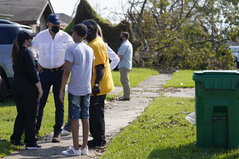 President Joe Biden talks as he tours a neighborhood impacted by Hurricane Ida, Friday, Sept. 3, 2021, in LaPlace, La. (AP Photo/Evan Vucci)