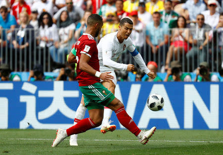 Soccer Football - World Cup - Group B - Portugal vs Morocco - Luzhniki Stadium, Moscow, Russia - June 20, 2018 Morocco's Medhi Benatia in action with Portugal's Cristiano Ronaldo REUTERS/Kai Pfaffenbach