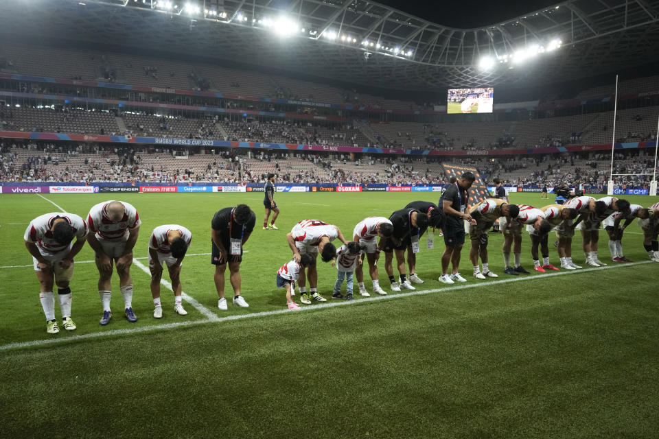 The Japanese players bow before their fans after the end of the Rugby World Cup Pool D match between England and Japan in the Stade de Nice, in Nice, France Sunday, Sept. 17, 2023. (AP Photo/Pavel Golovkin)