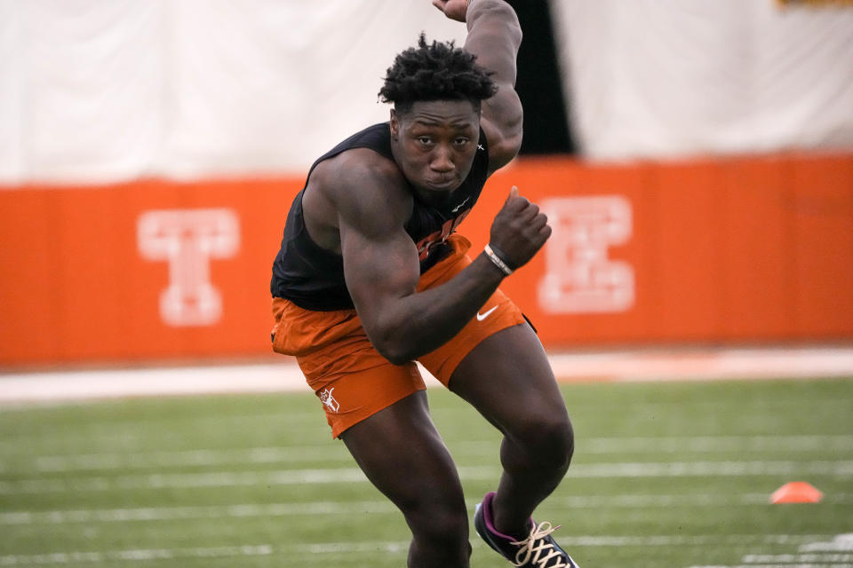 Former Texas linebacker DeMarvion Overshown goes through an agility drill at the Longhorns' annual pro timing day in March. The outside linebacker is projected as a middle-round pick in the NFL draft.