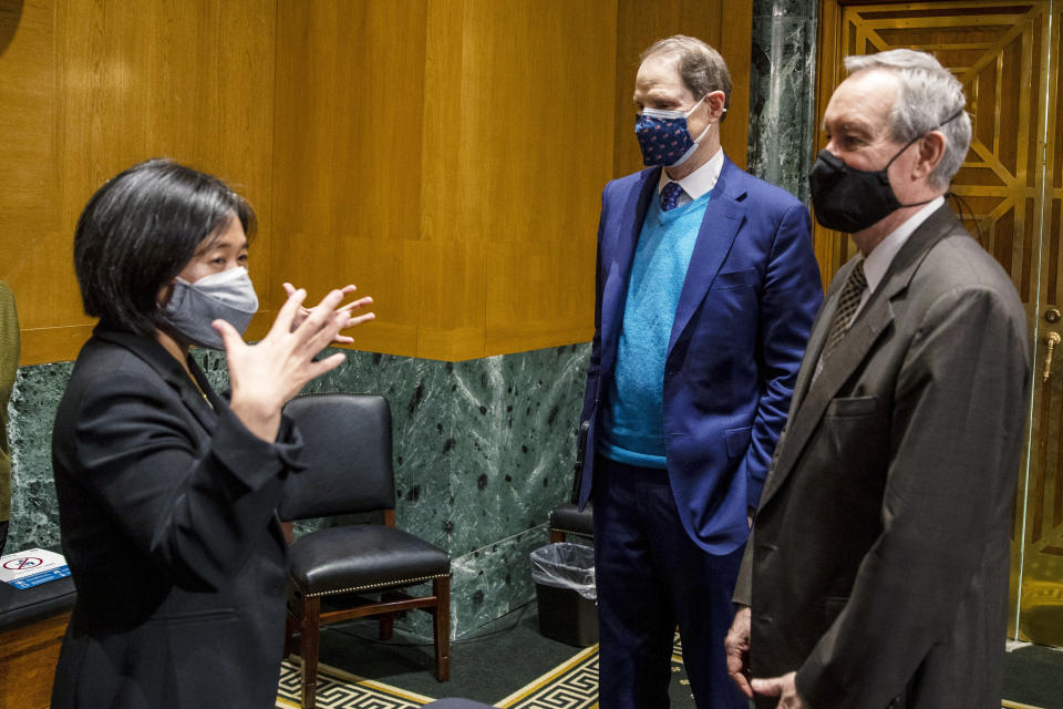 Katherine Tai, nominee for U.S. Trade Representative, greets Senate Finance Committee Chairman Sen. Ron Wyden, D-Oregon, and Sen. Michael Crapo, R-Idaho, after the Senate Finance Committee hearing, Thursday, Feb. 25, 2021 on Capitol Hill Washington. (Tasos Katopodis/Pool via AP)