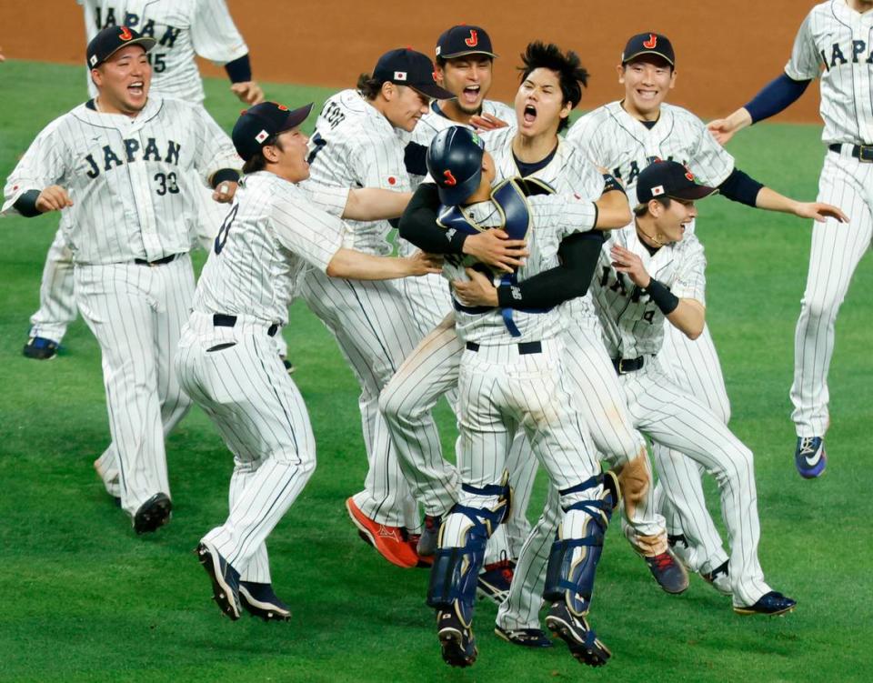 Japan pitcher Shohei Ohtani (16) and catcher Yuhei Nakamura (27) celebrate on the field with teammates after defeating the United States during the World Baseball Classic Championship Game at loanDepot Park in Miami, Fla. on Tuesday, March 21, 2023.