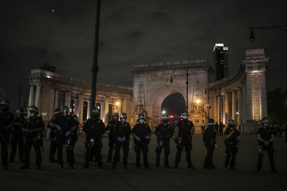 Police guard the entrance to the Manhattan Bridge that heads towards Brooklyn as protesters try to cross over during a solidarity rally calling for justice over the death of George Floyd Tuesday, June 2, 2020, in New York. Floyd died after being restrained by Minneapolis police officers on May 25. (AP Photo/Wong Maye-E)