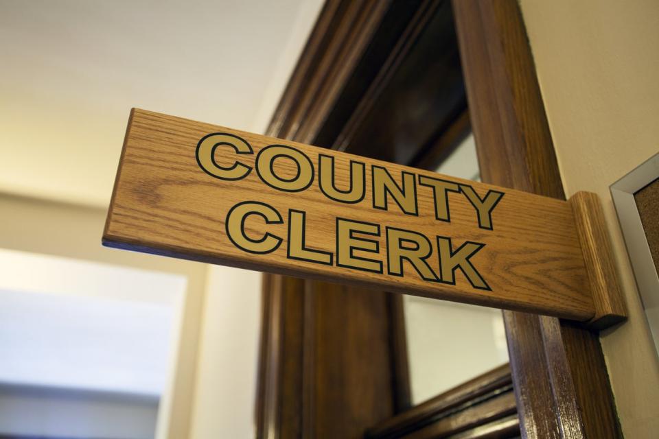 Interior wood sign for the county clerk's office.