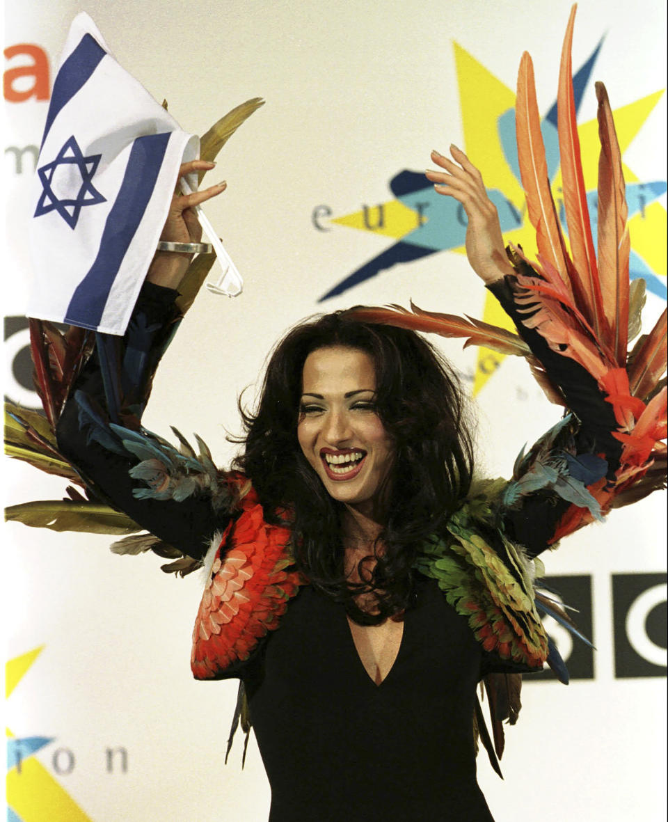 FILE - Israeli singer Dana International celebrates her victory in the Eurovision Song Contest at the Birmingham Indoor Arena, England, Sunday May 10, 1998. The 68th Eurovision Song Contest is taking place in May in Malmö, Sweden. It will see acts from 37 countries vie for the continent’s pop crown. Founded in 1956, Eurovision is a feelgood extravaganza that strives to banish international strife and division. It’s known for songs that range from anthemic to extremely silly, often with elaborate costumes and spectacular staging. (AP Photo/Louisa Buller, File)