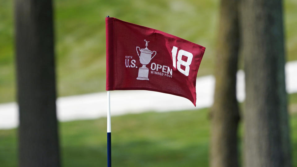 The pin flag for the 18th green flutters in the afternoon breeze during a practice round before the U.S. Open Championship golf tournament, Tuesday, Sept. 15, 2020, at the Winged Foot Golf Club in Mamaroneck, N.Y. (AP Photo/Charles Krupa)