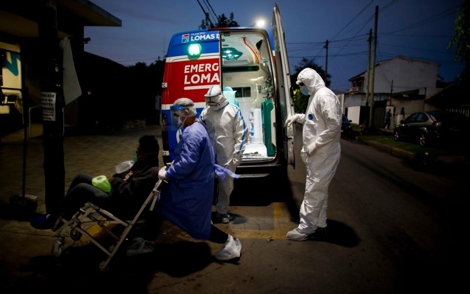 Heath workers admit a Covid patient at the Dr. Norberto Raul Piacentini hospital, as Argentina experiences record coronavirus tolls, hospitals struggle to keep up with the demand - AP Photo/Natacha Pisarenko