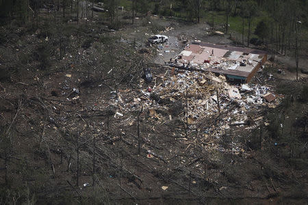 Residents go through the rubble of their home, one day after it was destroyed by a tornado near Vilonia, Arkansas April 28, 2014. REUTERS/Carlo Allegri
