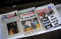 Front pages of South African newspapers featuring Olympic sprinter Oscar Pistorius' court appearance are displayed on February 20, 2013 outside the Magistrate Court in Pretoria. Witnesses claimed they heard arguing, a woman screaming and gunfire at the house of "Blade Runner" Oscar Pistorius the night he shot dead his model girlfriend, police told a South African court Wednesday