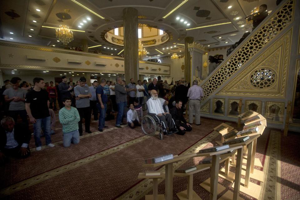 Palestinians pray in a new mosque, partially funded by Chechnya, in the Arab village of Abu Ghosh, on the outskirts of Jerusalem, Sunday, March 23, 2014. Isa Jabar, the mayor of the village, says Chechnya donated $6 million for the new mosque and that some Abu Ghosh residents trace their ancestry to 16th century Chechnya and the Caucus region. (AP Photo/Sebastian Scheiner)