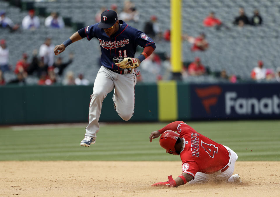 Minnesota Twins shortstop Jorge Polanco, top, leaps over Los Angeles Angels' Luis Rengifo after forcing him out at second base on a ground ball by Kole Calhoun during the fifth inning of a baseball game Thursday, May 23, 2019, in Anaheim, Calif. (AP Photo/Marcio Jose Sanchez)