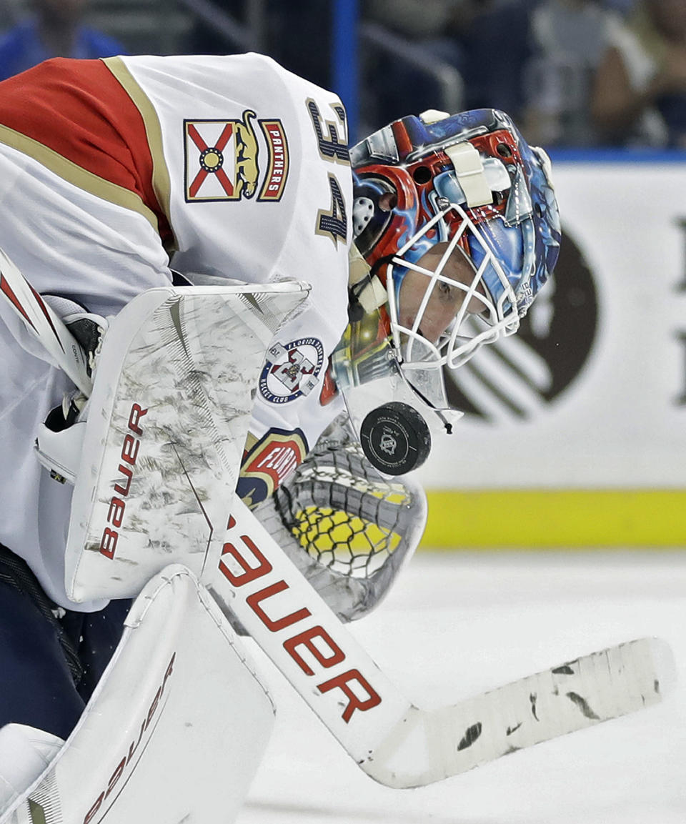 FILE - In this Sept. 25, 2018, file photo, Florida Panthers goaltender James Reimer (34) makes a save on a shot by the Tampa Bay Lightning during the second period of an NHL preseason hockey game, in Tampa, Fla. Reimer keeps flinching and he doesnt like it. Officials are in the process of addressing problems with the hope of making goalies feel safe in chest protectors that are roughly an inch smaller and tighter to the body. (AP Photo/Chris O'Meara, File)