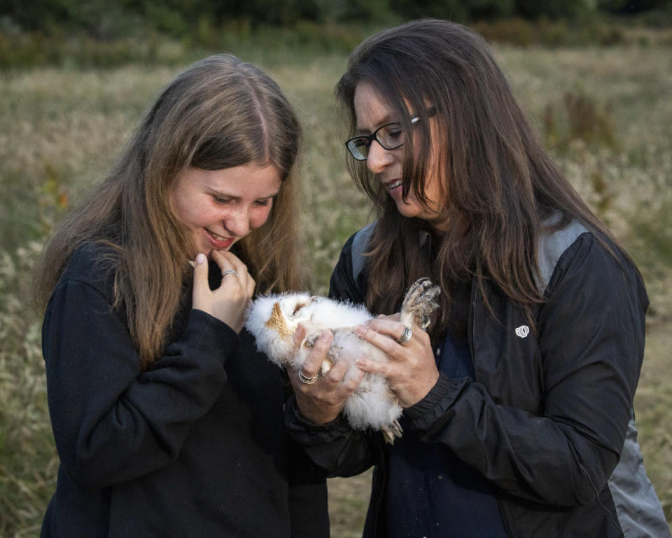 Roisin McDade with her daughter Erin holds one of the owlets (Liam McBurney/PA)