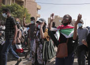 Sudanese calling for a civilian government march near the presidential palace in Khartoum, Sudan, Tuesday, Nov. 30, 2021. Security forces have fired tear gas at anti-coup protesters in the Sudanese capital on Tuesday, in the latest demonstrations against a military takeover that took place last month. (AP Photo/Marwan Ali)