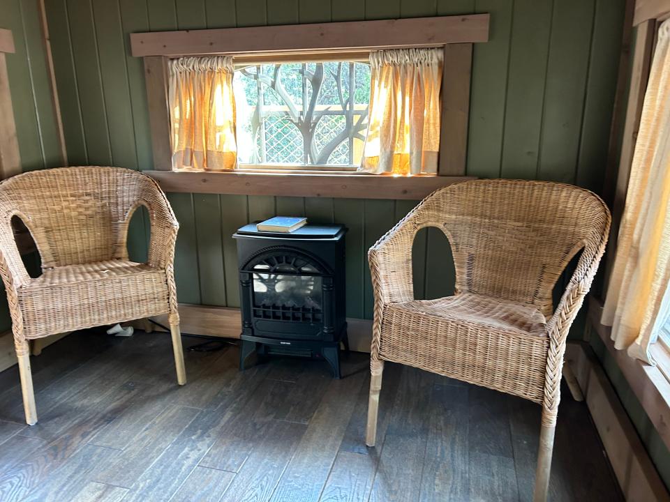 chairs and small faux fireplace on second floor