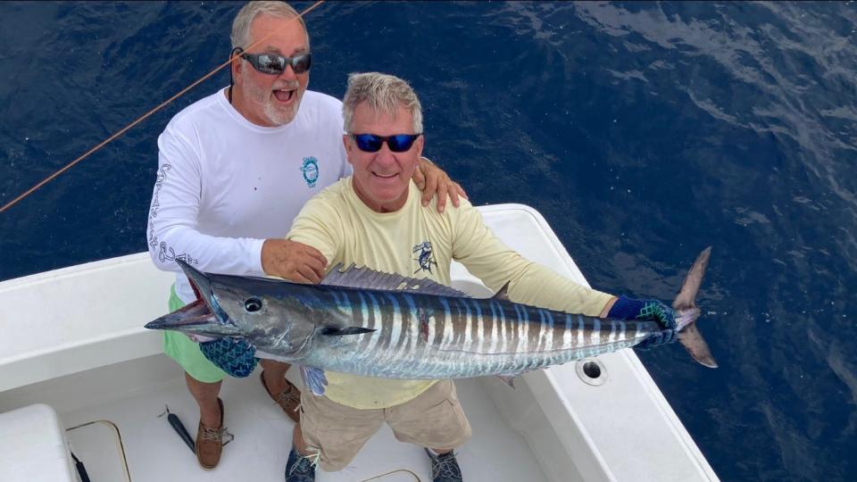 Palm Beach resident Chris Kellogg (left) and Bob Hayes hold a wahoo they caught while fishing between Palm Beach and Jupiter on Saturday. They caught this impressive fish trolling ballyhoo in 130 to 250 feet of water.