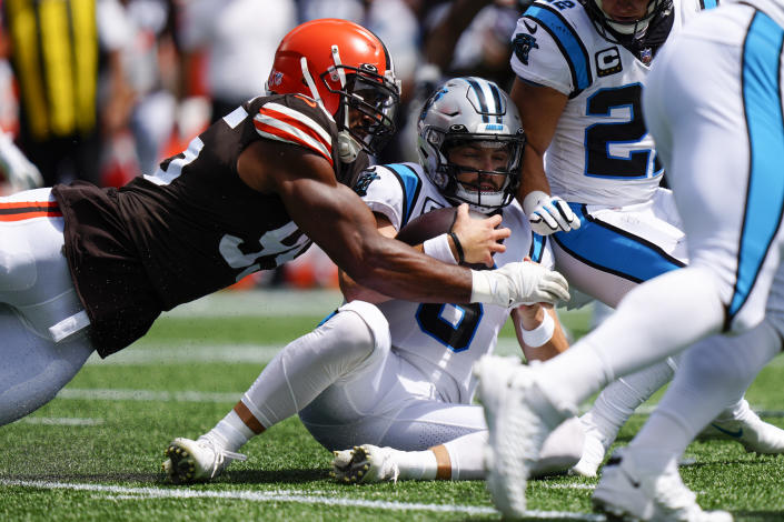 Carolina Panthers quarterback Baker Mayfield is tackled by Cleveland Browns defensive end Myles Garrett after recovering his own fumble during the first quarter of an NFL football game on Sunday, Sept. 11, 2022, in Charlotte, N.C. (AP Photo/Jacob Kupferman)