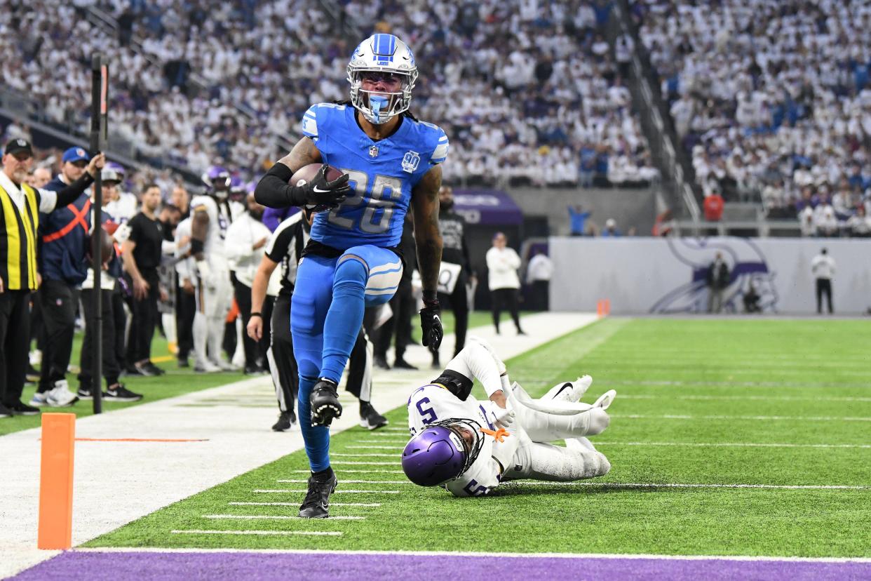 Lions running back Jahmyr Gibbs scores a rushing touchdown against Vikings defensive back Mekhi Blackmon during the second quarter on Sunday, Dec. 24, 2023, in Minneapolis.