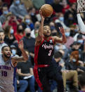 Portland Trail Blazers guard CJ McCollum, right, shoots in front of Detroit Pistons guard Cory Joseph during the second half of an NBA basketball game in Portland, Ore., Tuesday, Nov. 30, 2021. (AP Photo/Craig Mitchelldyer)