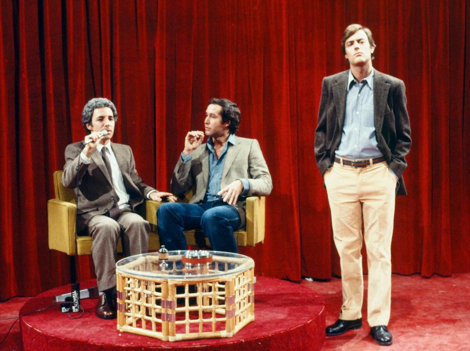 Harry Shearer, Chevy Chase, and Peter Aykroyd on stage
