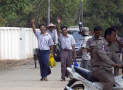 Reuters journalists Wa Lone, left, and Kyaw She Oo, third left, wave as they walk out from Insein Prison after being released in Yangon, Myanmar Tuesday, May 7, 2019. The chief of Yangon's Insein Prison said two Reuters journalists who were imprisoned for breaking the country's Officials Secrets Act have been released. (AP Photo/Thein Zaw)