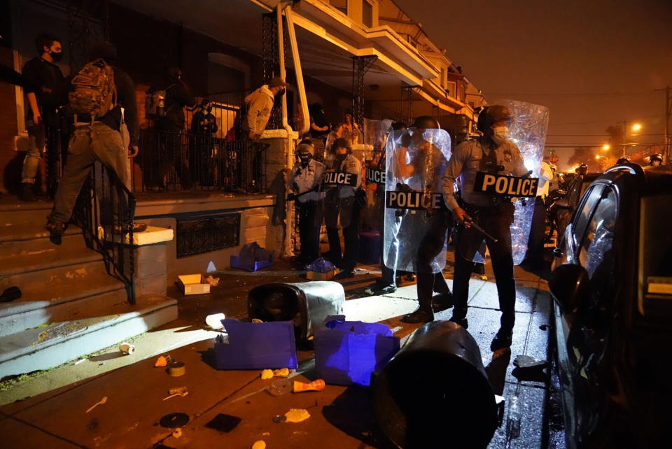 People gather in protest in response to the police shooting of Walter Wallace Jr., Monday, Oct. 26, 2020, in Philadelphia. Police officers fatally shot the 27-year-old Black man during a confrontation Monday afternoon in West Philadelphia that quickly raised tensions in the neighborhood. (Jessica Griffin/The Philadelphia Inquirer via AP)