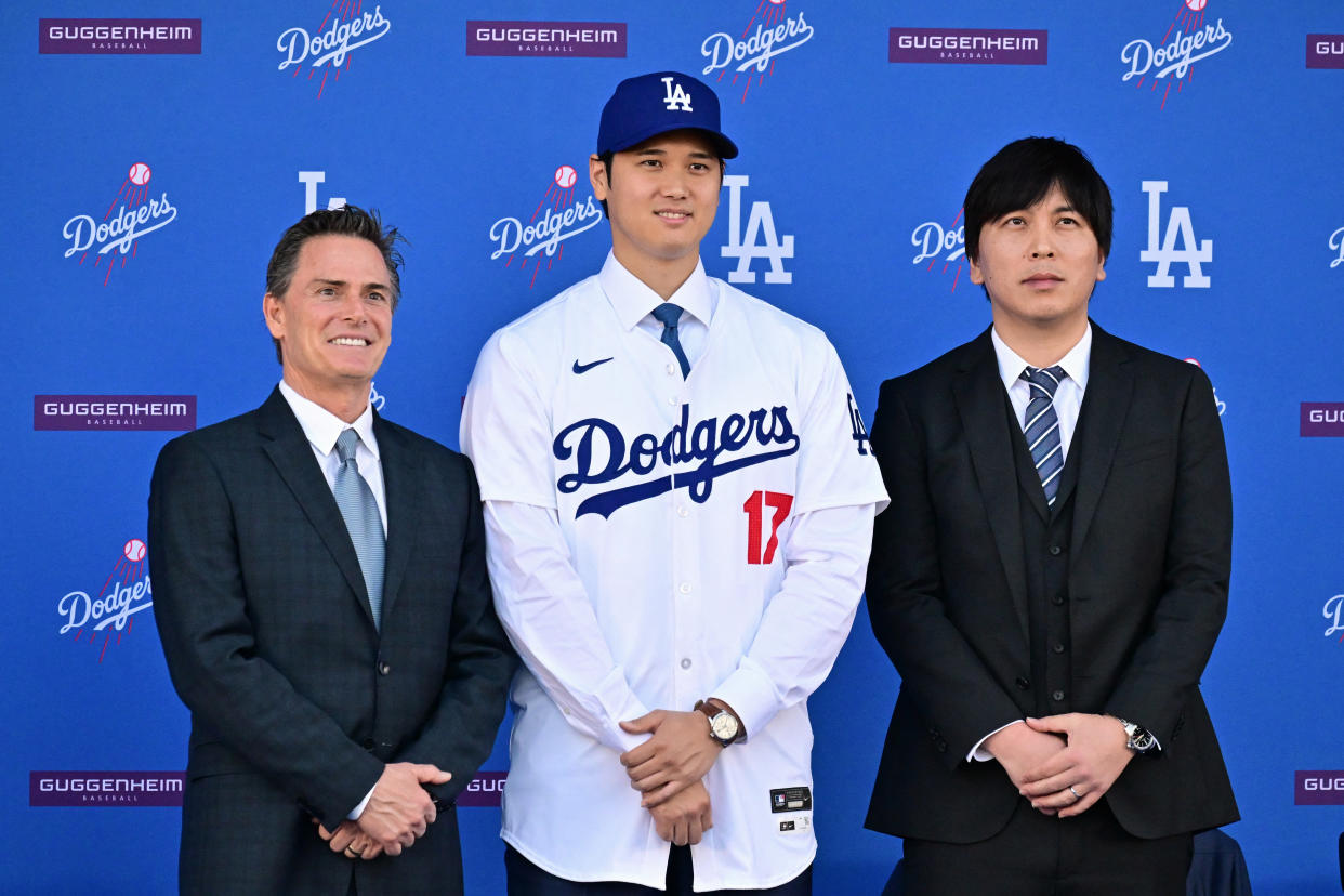 Shohei Ohtani with his agent, Nez Balelo (left), and former interpreter, Ippei Mizuhara, during his introductory Dodgers news conference in December. (Photo by Frederic J. Brown / AFP via Getty Images)