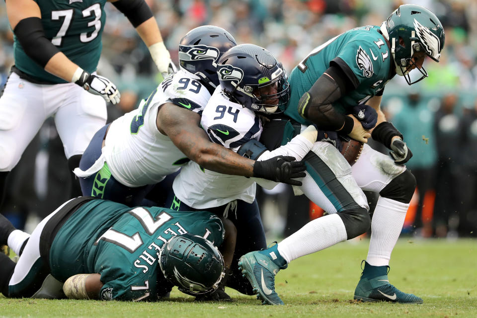 PHILADELPHIA, PENNSYLVANIA - NOVEMBER 24: Quinton Jefferson #99 and Ezekiel Ansah #94 of the Seattle Seahawks sack quarterback Carson Wentz #11 of the Philadelphia Eagles in the first half at Lincoln Financial Field on November 24, 2019 in Philadelphia, Pennsylvania. (Photo by Elsa/Getty Images)