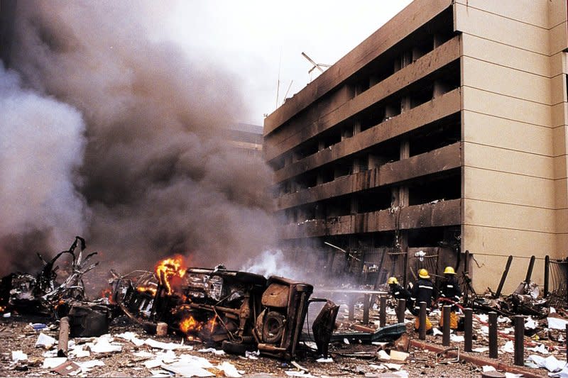Fire and rescue workers are on the scene moments after a blast at the U.S. Embassy in the Kenyan capital early August 7, 1998, killed more than 40 people. Moments later, a second bomb exploded outside the U.S. Embassy in Dar Es Salam, Tanzania. UPI File Photo