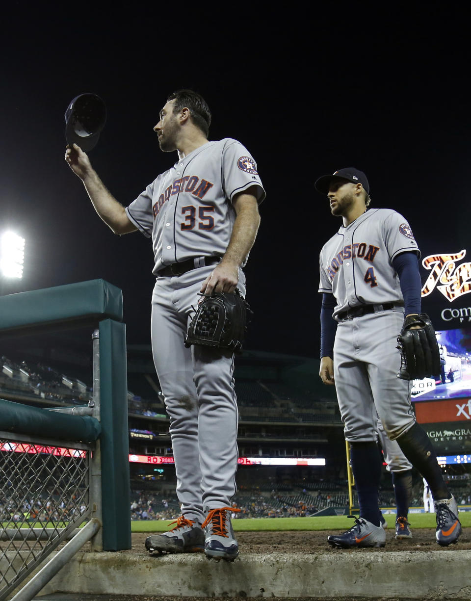 Houston Astros starting pitcher Justin Verlander (35) acknowledges the crowd as he walks off the field at Comerica Park with teammate George Springer following the seventh inning of a baseball game against the Detroit Tigers , Monday, Sept. 10, 2018, in Detroit. (AP Photo/Duane Burleson)