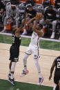 Brooklyn Nets' Kevin Durant shoots against Milwaukee Bucks forward Khris Middleton (22) during the first half of Game 6 of a second-round NBA basketball playoff series Thursday, June 17, 2021, in Milwaukee. (AP Photo/Jeffrey Phelps)