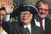 FILE - Then Chinese President Jiang Zemin waves to the crowd after being given a tricorn colonial hat as he arrives at the Governor's Palace in Williamsburg, Va., Oct. 28, 1997. Chinese state TV said Wednesday, Nov. 30, 2022, that Jiang has died at age 96. (AP Photo/Doug Mills, File)
