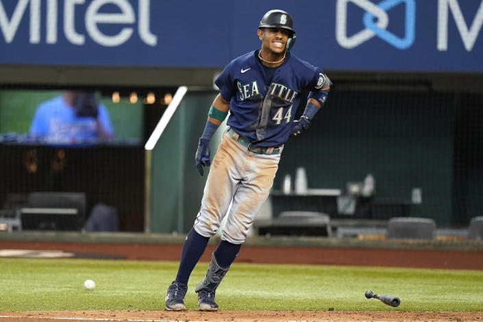 Seattle Mariners Julio Rodriguez (44) reacts to getting hit by a pitch from Texas Rangers starting pitcher Glenn Otto during the third inning of a baseball game against the Texas Rangers in Arlington, Texas, Sunday, July 17, 2022. (AP Photo/LM Otero)