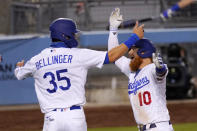 Los Angeles Dodgers' Justin Turner, right, celebrates with Cody Bellinger after hitting a three-run home run during the sixth inning of a baseball game against the San Francisco Giants, Saturday, Aug. 8, 2020, in Los Angeles. (AP Photo/Mark J. Terrill)