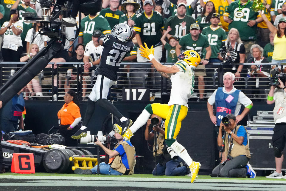 Oct 9, 2023; Paradise, Nevada, USA; Las Vegas Raiders cornerback Amik Robertson (21) intercepts a pass intended for Green Bay Packers wide receiver Christian Watson (9) at the end of the fourth quarter at Allegiant Stadium. Mandatory Credit: Stephen R. Sylvanie-USA TODAY Sports