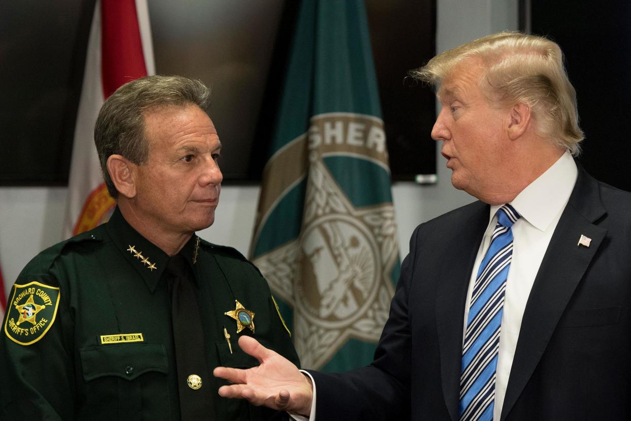 US President Donald Trump speaks with Broward County Sheriff Scott Israel while visiting first responders at Broward County Sheriff's Office: AFP/Getty