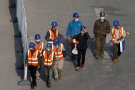 Workers leave a construction site at the end of their shift in the Central Business District in Beijing