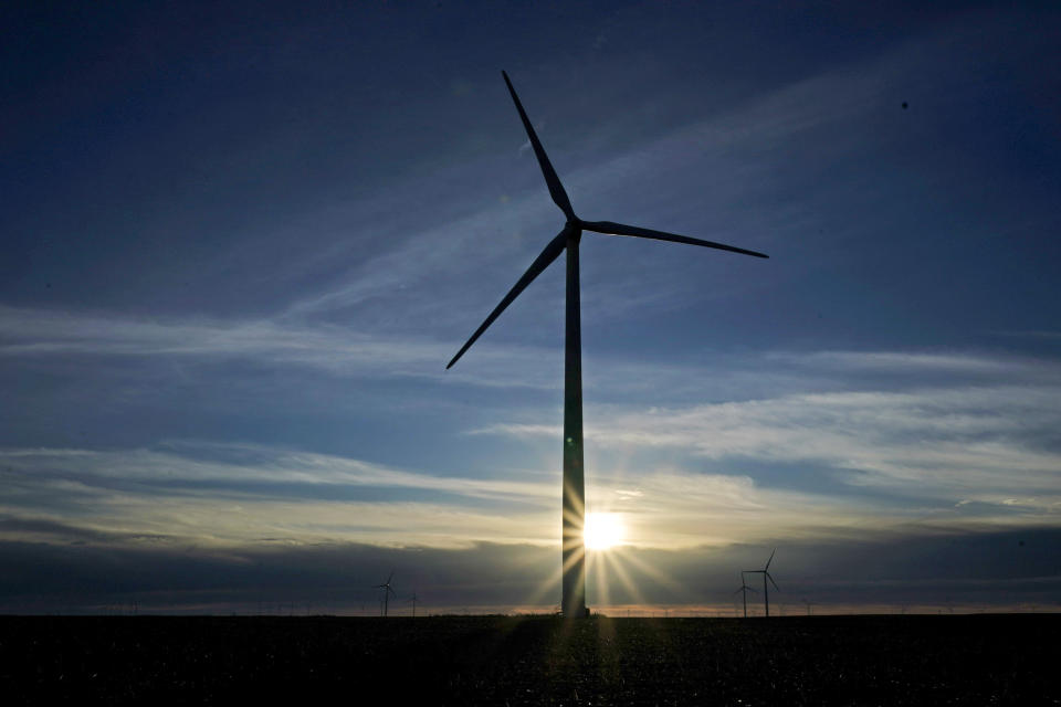 FILE - In this Jan. 13, 2021, file photo a wind turbine is silhouetted against the rising sun Wednesday, Jan. 13, 2021, near Spearville, Kan. Recent detailed scientific studies show that because of dropping wind, solar and battery prices, President Joe Biden's net-zero carbon goal can be accomplished far cheaper than feared in the past and with health benefits “many, many times'' outweighing the costs, said Princeton University ecologist Stephen Pacala, who was part of one study at Princeton. (AP Photo/Charlie Riedel, File)