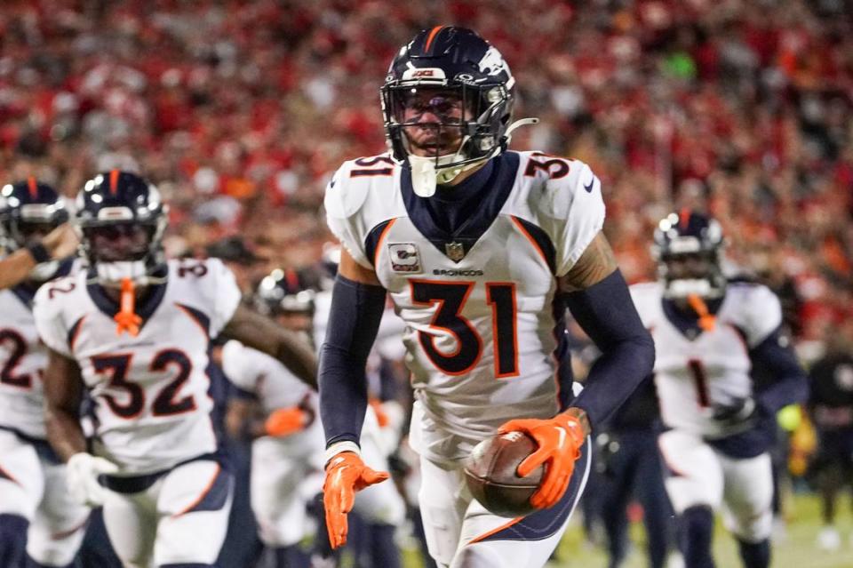 Oct 12, 2023; Kansas City, Missouri, USA; Denver Broncos safety Justin Simmons (31) celebrates after making an interception against the Kansas City Chiefs during the first half at GEHA Field at Arrowhead Stadium. Mandatory Credit: Denny Medley-USA TODAY Sports