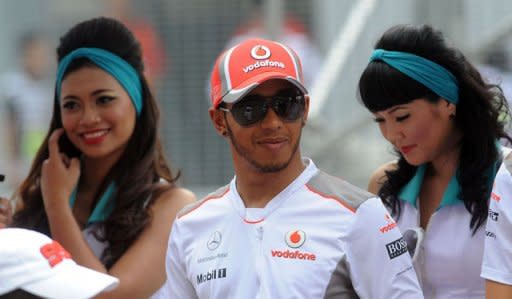 Pole-sitter Hamilton survived a furious challenge from team-mate Button