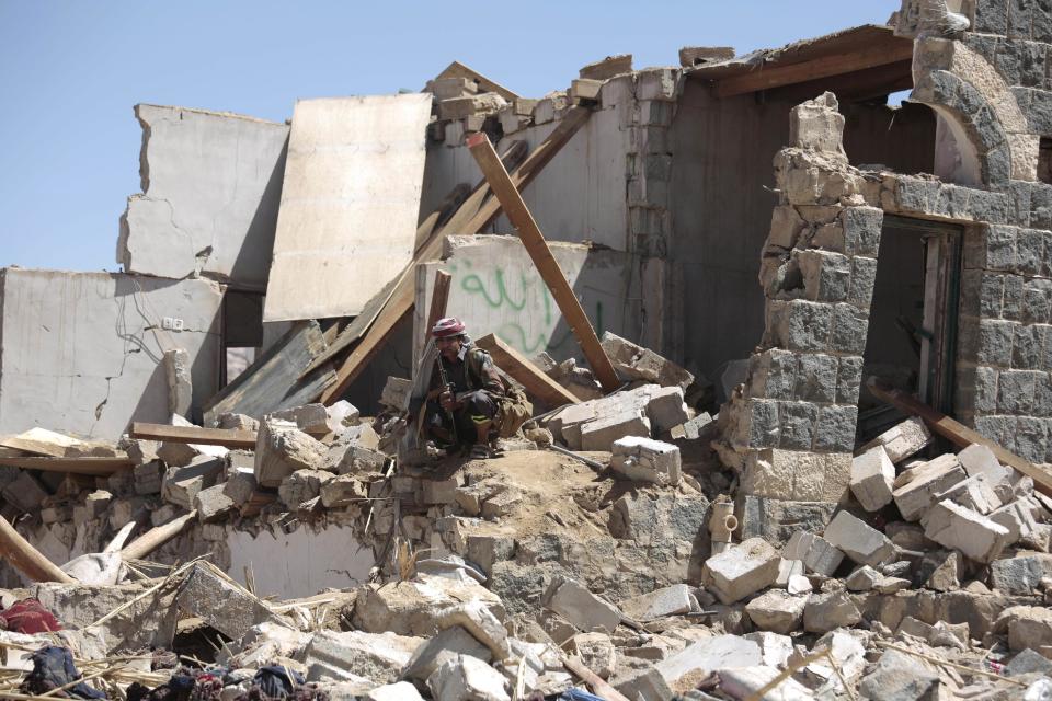 A man sits on the rubble of a house destroyed by a Saudi-led airstrike in the outskirts of Sanaa, Yemen, Thursday, Feb. 16, 2017. At least one Saudi-led airstrike near Yemen's rebel-held capital killed at least five people on Wednesday, the country's Houthi rebels and medical officials said. (AP Photo/Hani Mohammed)