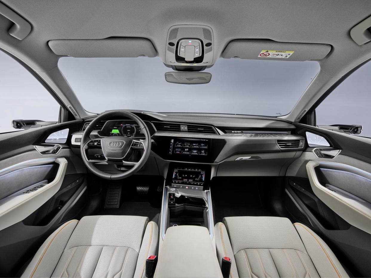 The interior of the car features dual touchscreens