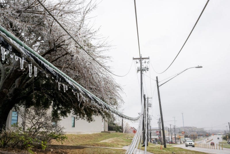 Frozen power lines are seen hanging near a sidewalk on February 01, 2023 in Austin, Texas. A winter storm is sweeping across portions of Texas, causing massive power outages and disruptions of highways and roads. 