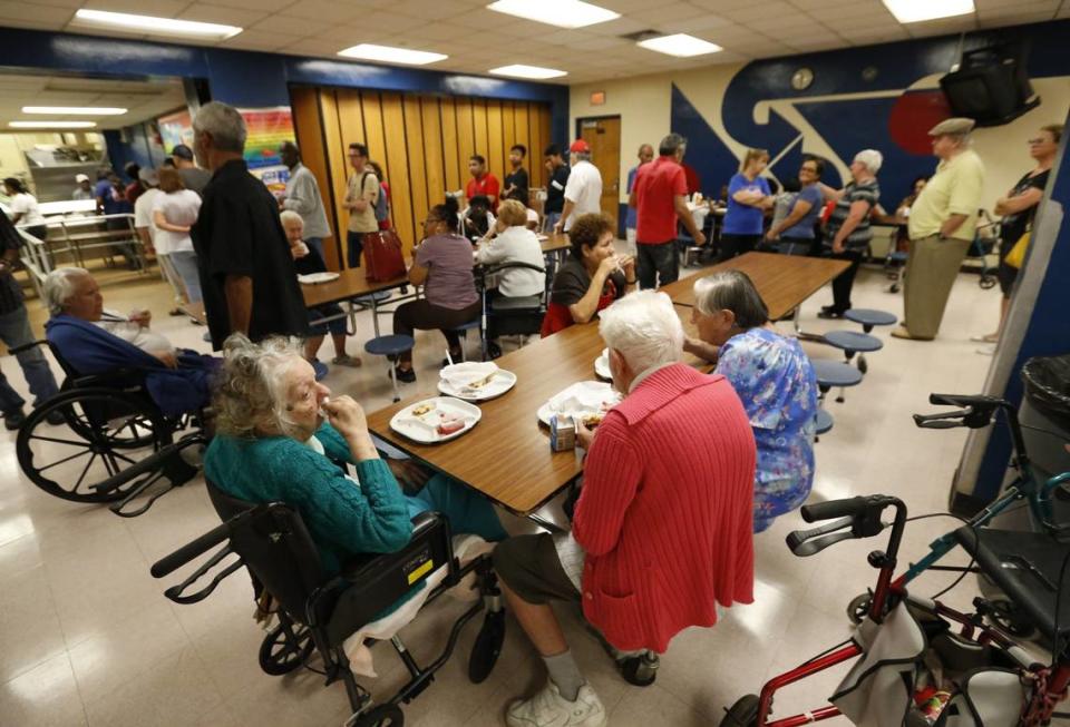 People at a Red Cross shelter set up at North Miami Beach Senior High School eat lunch, Friday, Sept. 8, 2017 before Irma made landfall in Florida.