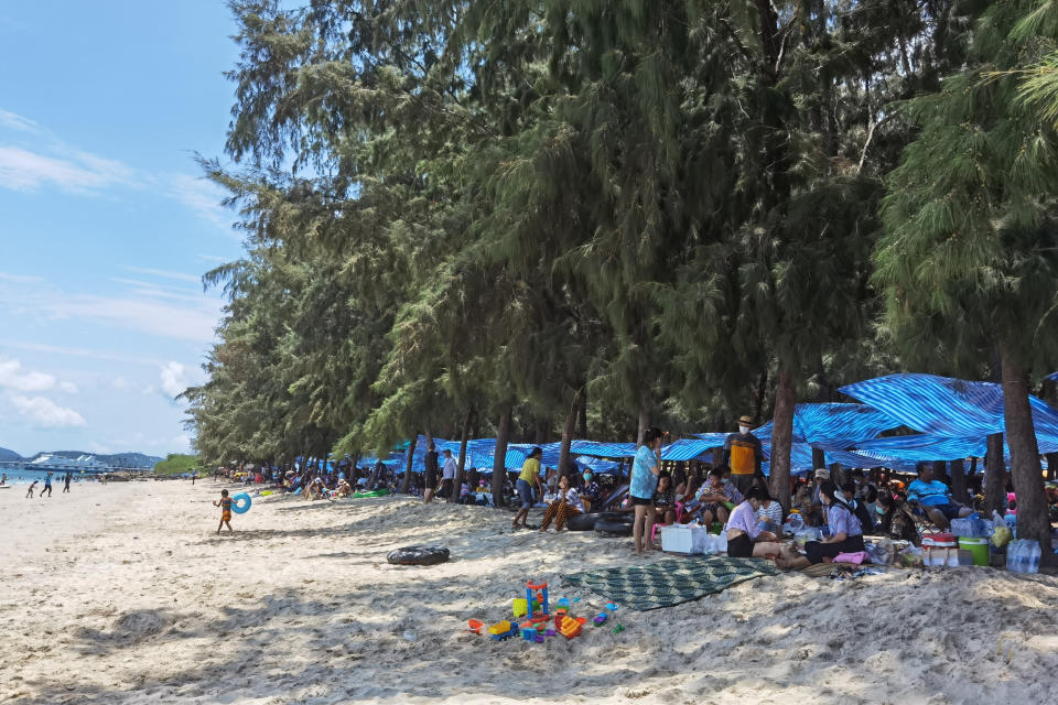 People gather together to celebrate the first day of the Songkran New Year holidays at Nang Rong beach in Chonburi, Thailand Tuesday, April 13, 2021. Thailand on Tuesday recorded almost 1,000 cases for the third straight day, as health officials worry that the number of new infections could be far higher after this week's traditional Thai New Year holiday. (AP Photo/Penny Yi Wang)