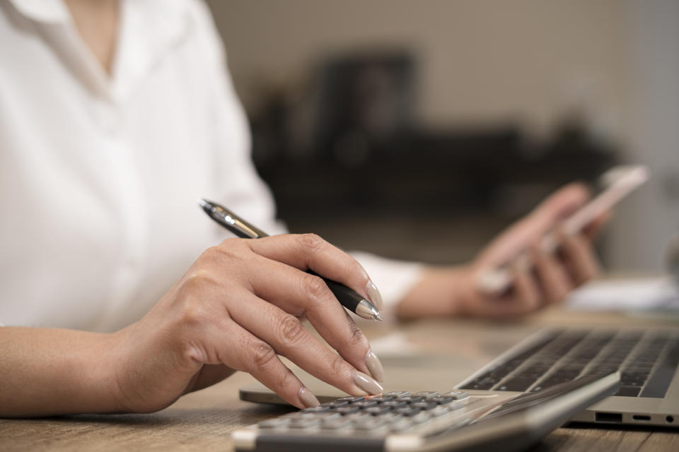 Finances and economy concept.Close up hand of business woman accountant or banker making calculations.