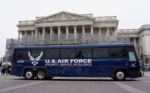 Air Force bus meant to transport Speaker of the Pelosi and other members of Congress to flight to Afghanistan sits in front of House of Representatives in Washington - Credit: Reuters