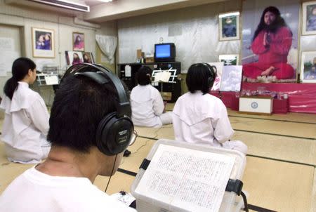 FILE PHOTO : Doomsday cult Aum Shinrikyo followers chant in religious training before a portrait of guru Shoko Asahara at Aum's Adachi office in Tokyo, Japan July 19, 1999. REUTERS/Eriko Sugita/File Photo